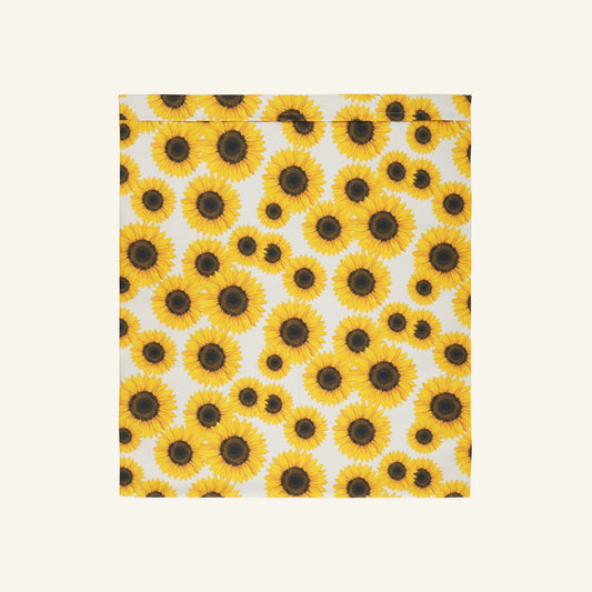 De waszak met witte achtergrond en print van gele zonnebloemen