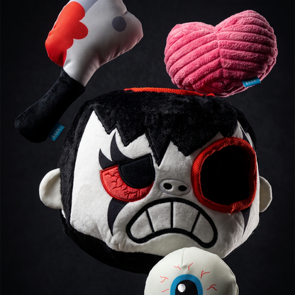 Zombiehoofd met lege ooggat, erboven het roze hart en het pluche hakmes