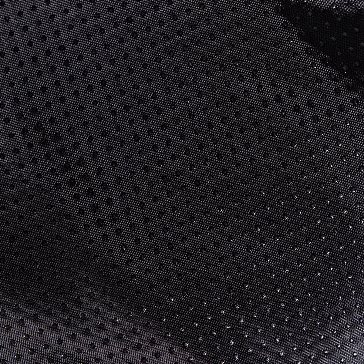 Close-up van zwarte stof met noppen, vermoedelijk de antislip onderkant