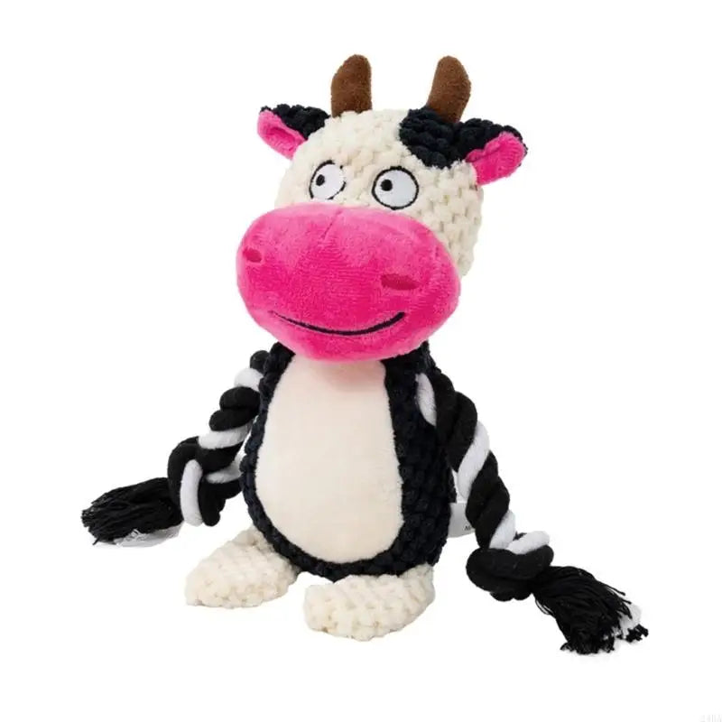 De knuffel als zwartwitte koe met roze snuit en hoorntjes